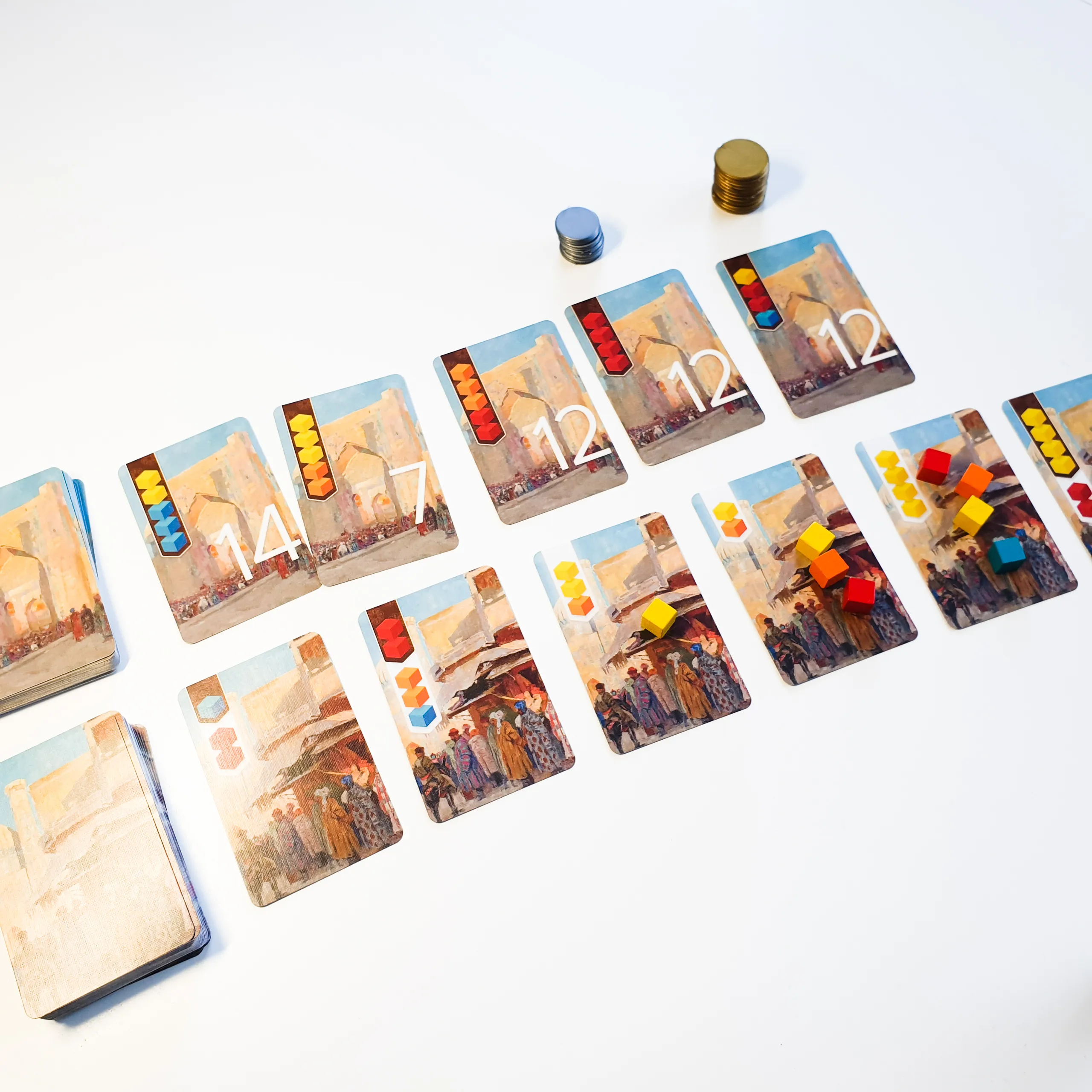 Game set up on the table with two rows of cards and some tokens