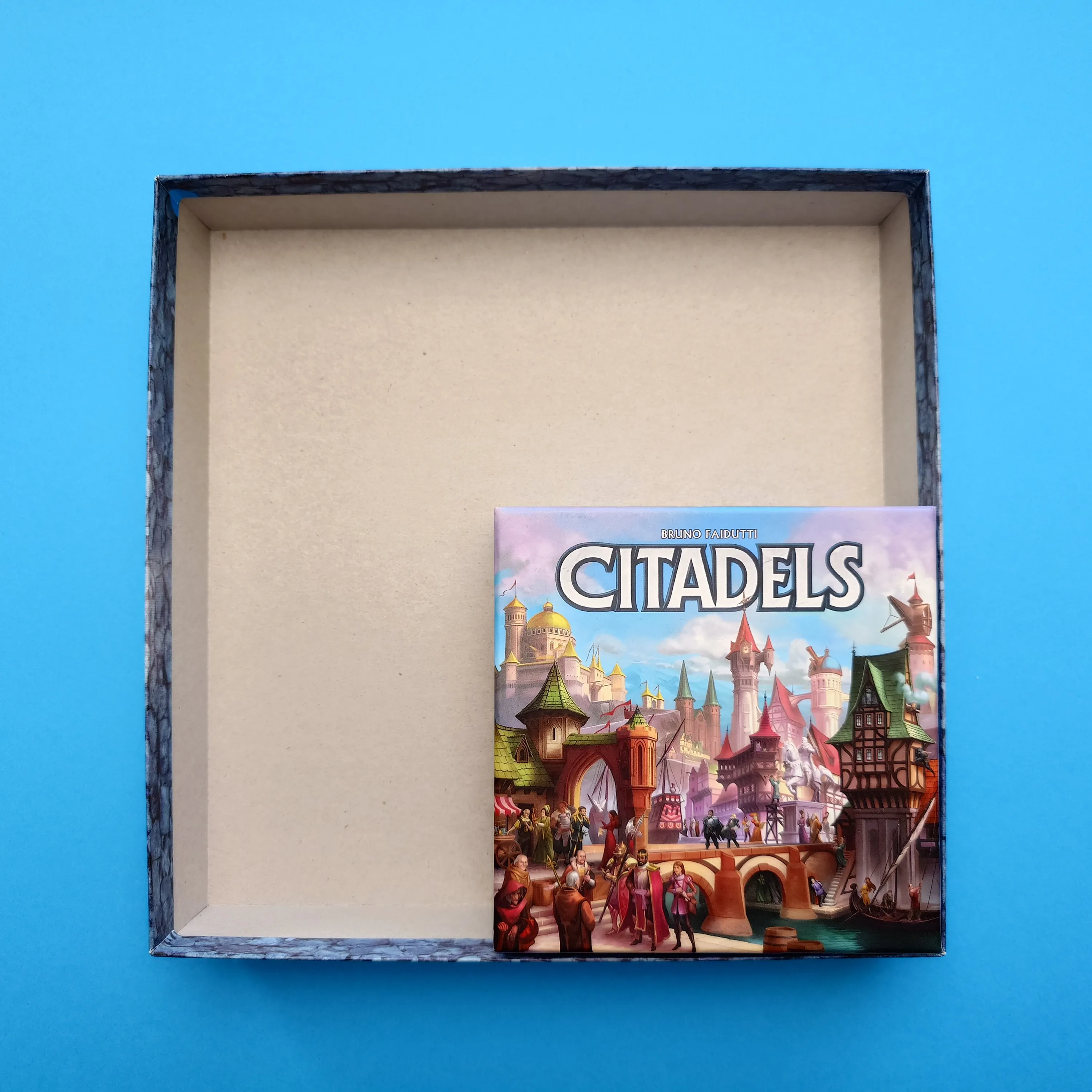 Smaller Citadels box sitting inside the much larger original box lid